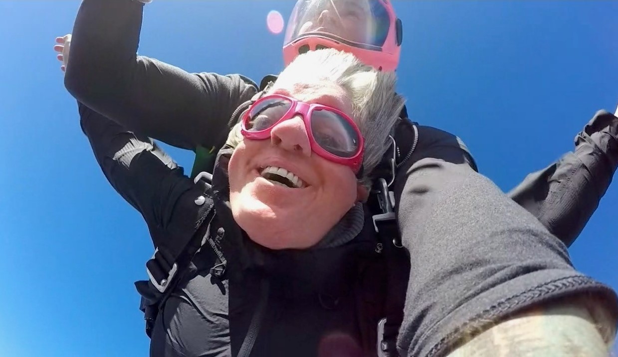 A close-up photo of Sarah’s smiling face from right below her