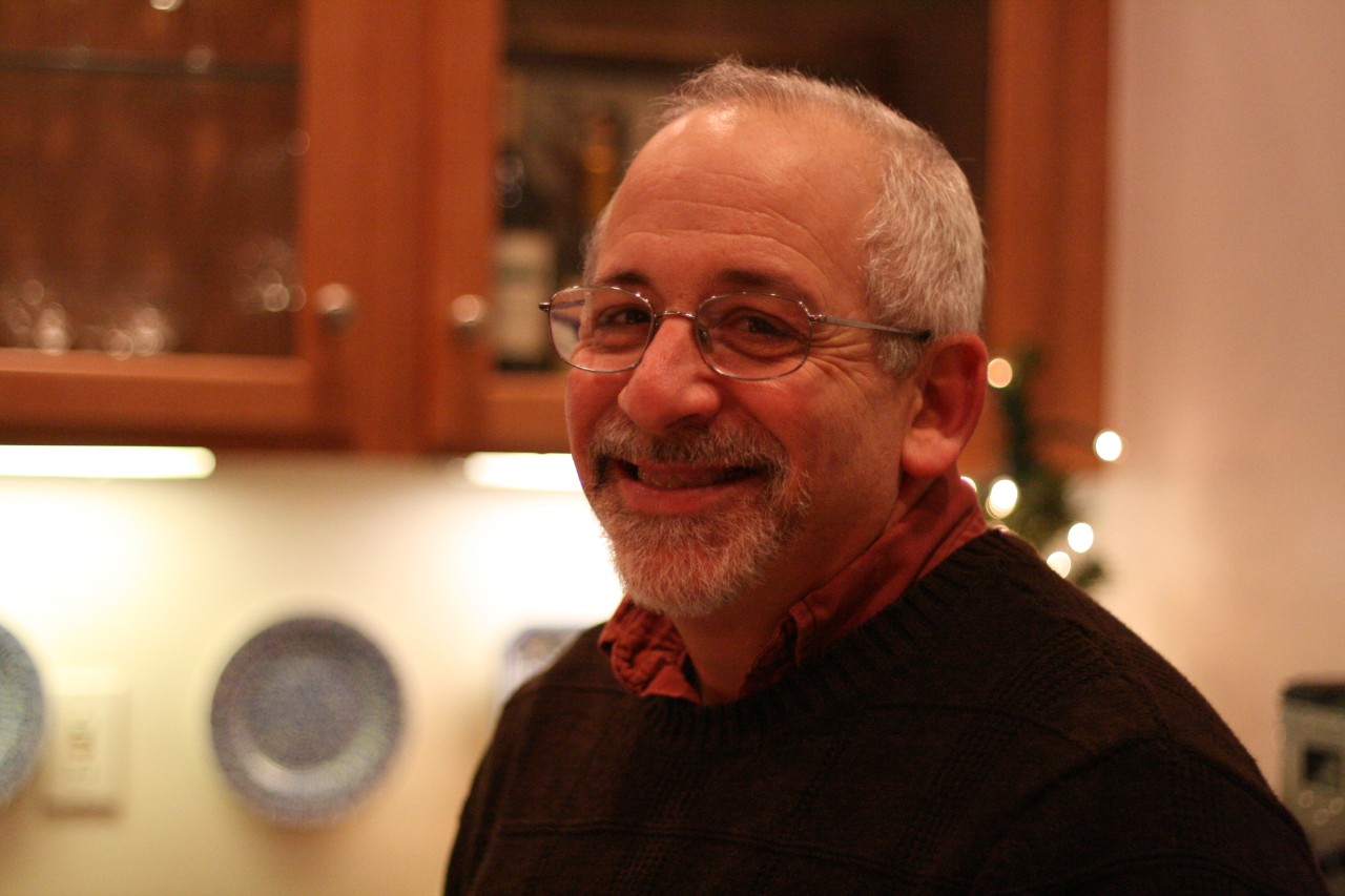 a warm smiling head shot of Ned at a Council holiday party a few years ago