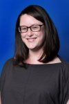 headshot of Emma Shouse Garton, a white woman with short brown hair, brown glasses and an olive green blouse