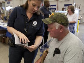 Hixon, TN, June 2, 2011 -- Emily Torres, a FEMA mitigation advisor, explains information in a brochure to a disaster survivor. FEMA personnel provide a large variety of mitiagation services with displays at local stores such as Home Depot. Photo by EdEdahl/FEMA. Hixon, TN, June 2, 2011 -- Emily Torres, a FEMA mitigation advisor, explains information in a brochure to a disaster survivor. FEMA personnel provide a large variety of mitiagation services with displays at local stores such as Home Depot. Photo by EdEdahl/FEMA.