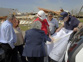Mena, AR, April 15, 2009 -- Mena, Ark. April 15, 2009 - Members of a city/county/state/federal Preliminary Damage Assessment team listen intently as the city of Mena clerk/treasurer (back to camera) and the mayor (left) go over a detailed mapping of areas of the city with damages and losses caused by an F3 tornado on the evening of April 9th. Five documented tornadoes struck several western Arkansas counties that night. FEMA Photo by Win Henderson Mena, AR, April 15, 2009 -- Mena, Ark. April 15, 2009 - Members of a city/county/state/federal Preliminary Damage Assessment team listen intently as the city of Mena clerk/treasurer (back to camera) and the mayor (left) go over a detailed mapping of areas of the city with damages and losses caused by an F3 tornado on the evening of April 9th. Five documented tornadoes struck several western Arkansas counties that night. FEMA Photo by Win Henderson