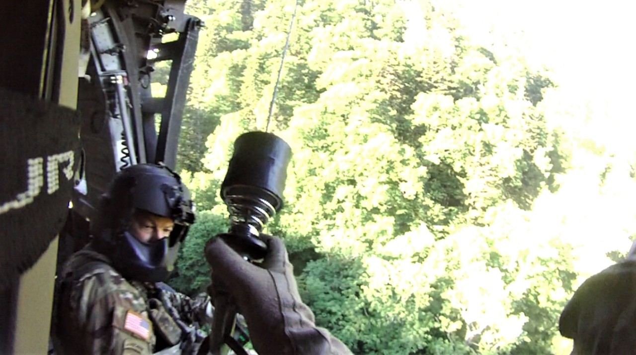Sgt. Tim Allen begins hoist operations and lowers Sgt. 1st Class Tracy Banta, a Critical Care Flight Paramedic, to a bear attack victim in the Great Smoky Mountain National Park Area, June 18. (Courtesy photo from the Tennessee National Guard) Sgt. Tim Allen begins hoist operations and lowers Sgt. 1st Class Tracy Banta, a Critical Care Flight Paramedic, to a bear attack victim in the Great Smoky Mountain National Park Area, June 18. (Courtesy photo from the Tennessee National Guard)