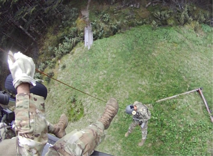 Tennessee Army National Guard Blackhawk helicopter crew chief, Sgt. Daniel Bandy, lowers flight paramedic, Sgt. 1st Class Nolan Ogle, to the ground by hoist to begin rescuing a hiker in respiratory distress in the Great Smoky Mountain National Park, at Mount LeConte Lodge, in the late afternoon of May 31.  (submitted photo) 