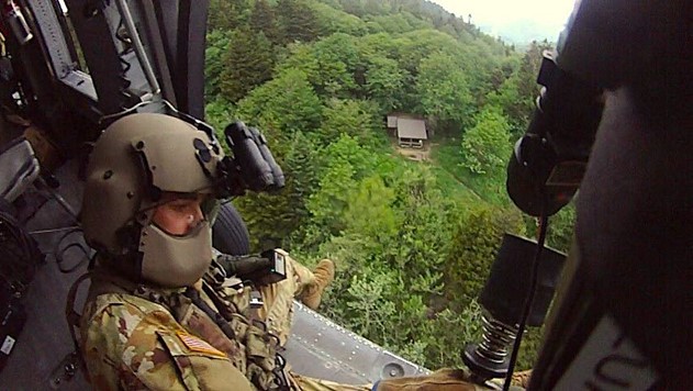 Tennessee Army National Guard Blackhawk helicopter crew chief, Sgt. Daniel Bandy, prepares to lower flight paramedic, Sgt. 1st Class Giovanni DeZuani, to the ground by hoist to begin rescuing a hiker in cardiac distress at the Double Spring Gap Shelter in the Great Smoky Mountains National Park, on the evening of June 12. (submitted photo) Tennessee Army National Guard Blackhawk helicopter crew chief, Sgt. Daniel Bandy, prepares to lower flight paramedic, Sgt. 1st Class Giovanni DeZuani, to the ground by hoist to begin rescuing a hiker in cardiac distress at the Double Spring Gap Shelter in the Great Smoky Mountains National Park, on the evening of June 12. (submitted photo)