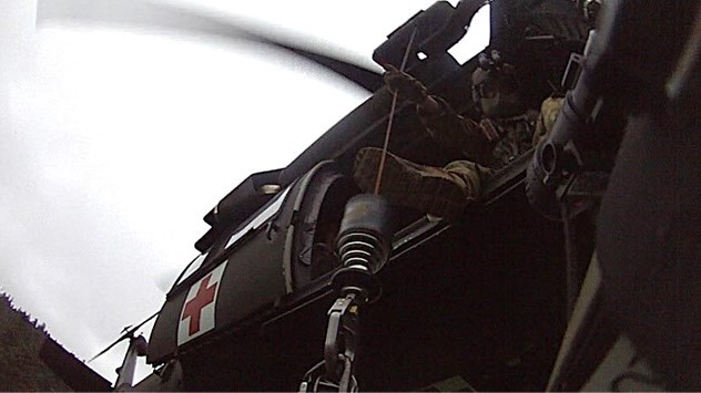Tennessee Army National Guard Blackhawk helicopter crew chief, Sgt. Daniel Bandy, hoists the hiker in cardiac distress and Sgt. 1st Class Giovanni DeZuani, the flight paramedic, into the helicopter at the Double Spring Gap Shelter in the Great Smoky Mountains National Park, on the evening of June 12. (submitted photo) Tennessee Army National Guard Blackhawk helicopter crew chief, Sgt. Daniel Bandy, hoists the hiker in cardiac distress and Sgt. 1st Class Giovanni DeZuani, the flight paramedic, into the helicopter at the Double Spring Gap Shelter in the Great Smoky Mountains National Park, on the evening of June 12. (submitted photo)